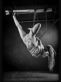 a black and white photo of a woman doing acrobatics